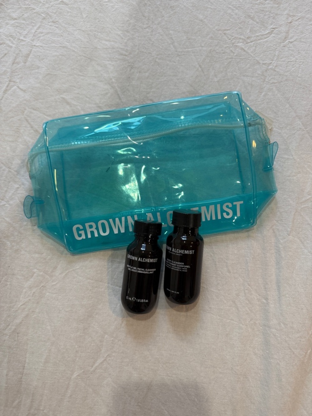 Grown Alchemist Turquoise Clear PVC Travel Pouch with Black Bottles